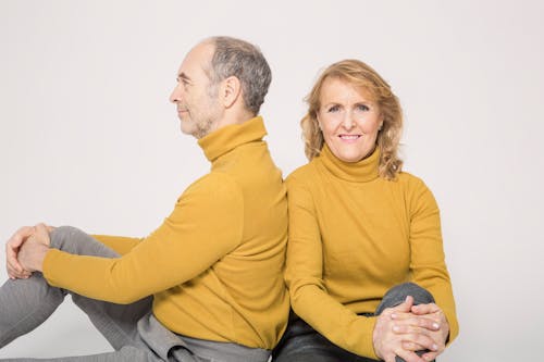 Man in Yellow Sweater Sitting Beside Woman in Yellow Sweater