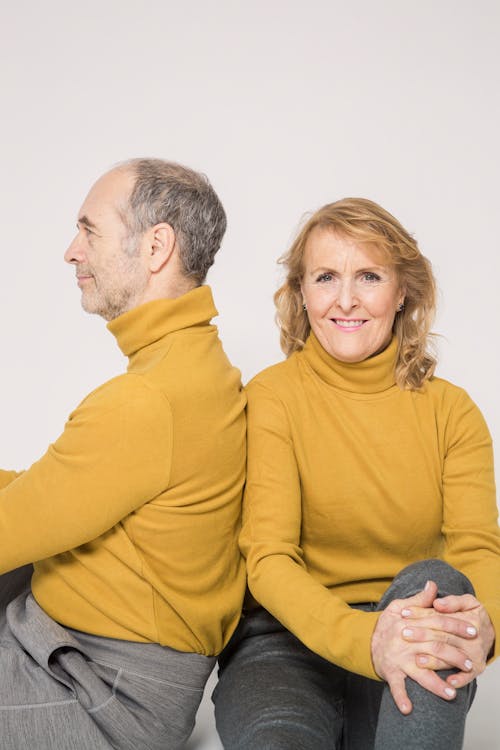 Man in Yellow Sweater Smiling Beside Woman in Yellow Sweater