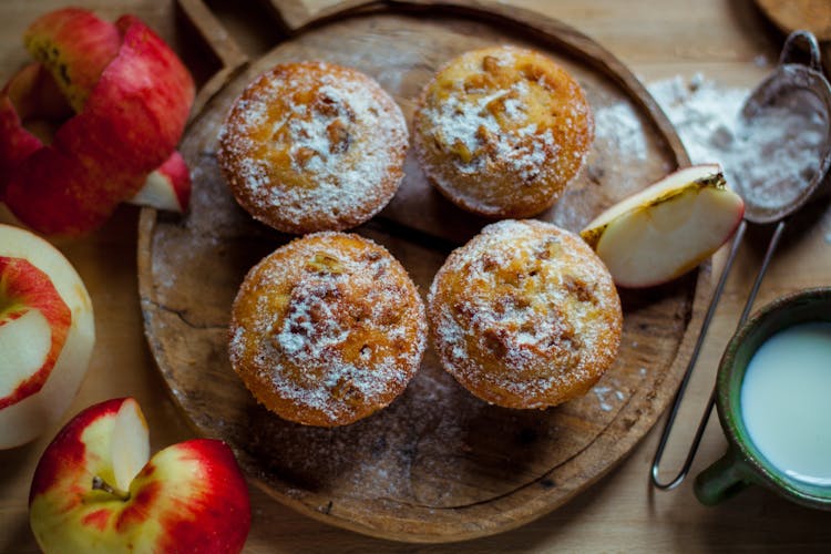 Homemade Sweet Muffins With Apples On Table