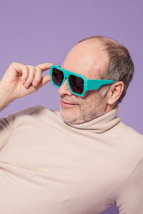 Man in Beige Turtleneck Sweater Wearing Green Sunglasses