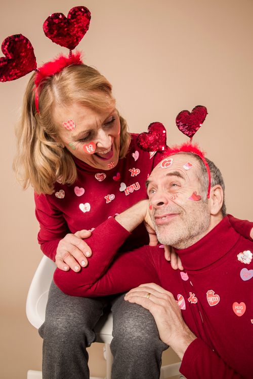 Free Elderly couple in matching red outfits celebrating Valentine's Day with love and joy. Stock Photo