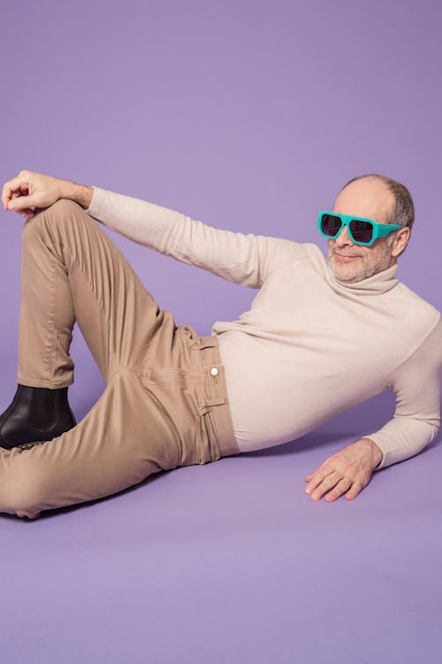 Man in Beige Turtleneck Sweater Wearing Green Sunglasses