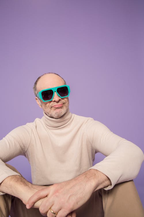 Man in Beige Turtleneck Sweater Wearing Green Sunglasses