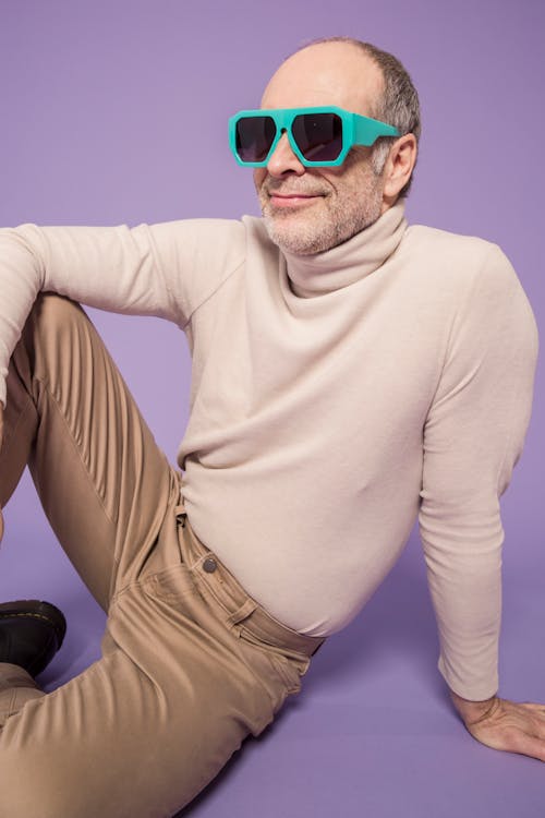 Man in Beige Turtleneck Sweater Wearing Green Sunglasses