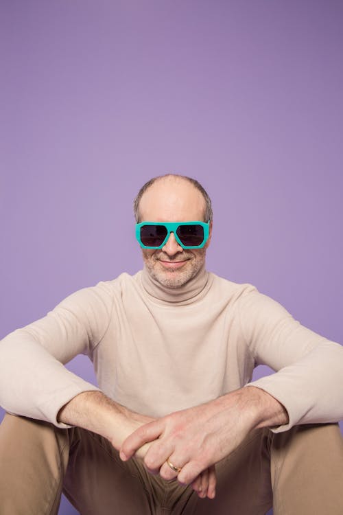 Man in Beige Turtleneck Sweater Wearing Green Sunglasses