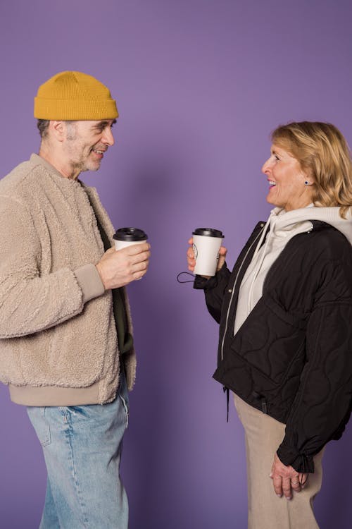 Woman in Black Zip Up Jacket Beside Man in Brown Jacket