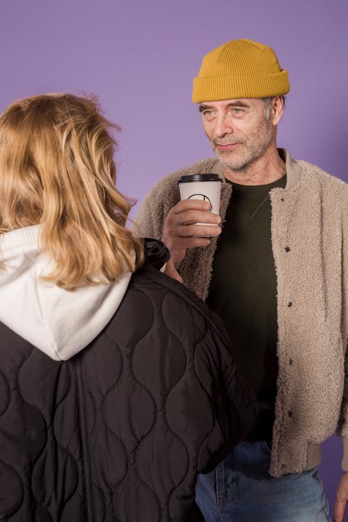 Couple Holding Cup of Coffee
