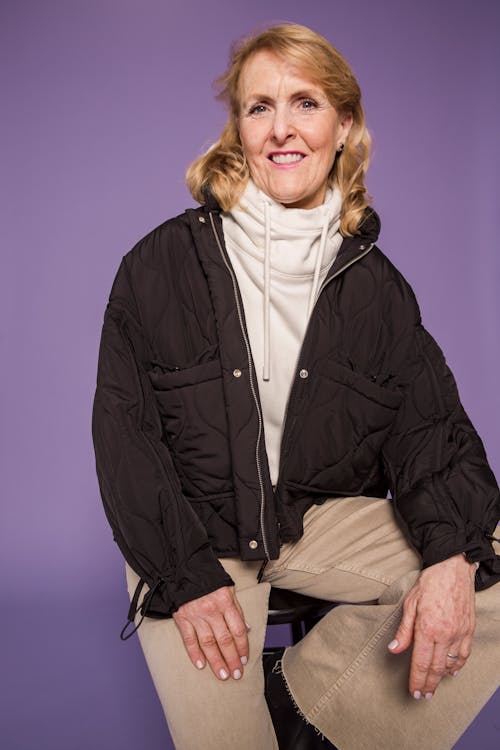 Woman in Black Jacket Sitting on Chair