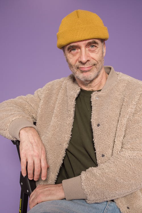 Man in Yellow Knit Cap and Brown Coat