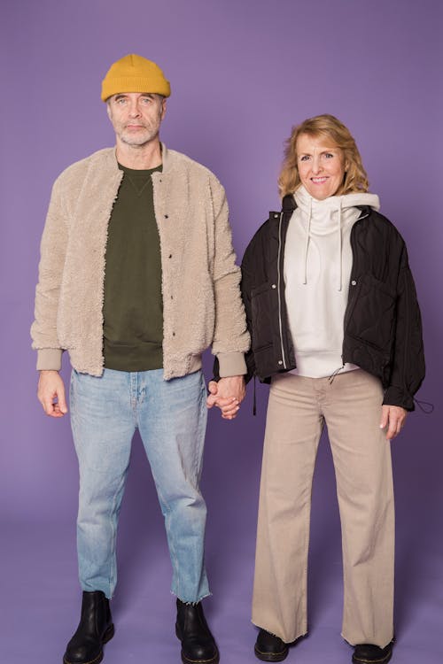 Woman in Black Zip Up Jacket Beside Man in Brown Jacket