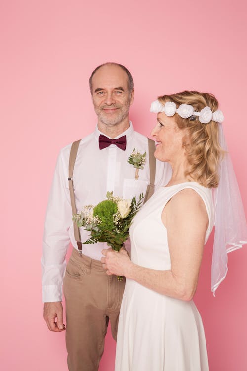 Man in White Dress Shirt and Woman in White Sleeveless Dress