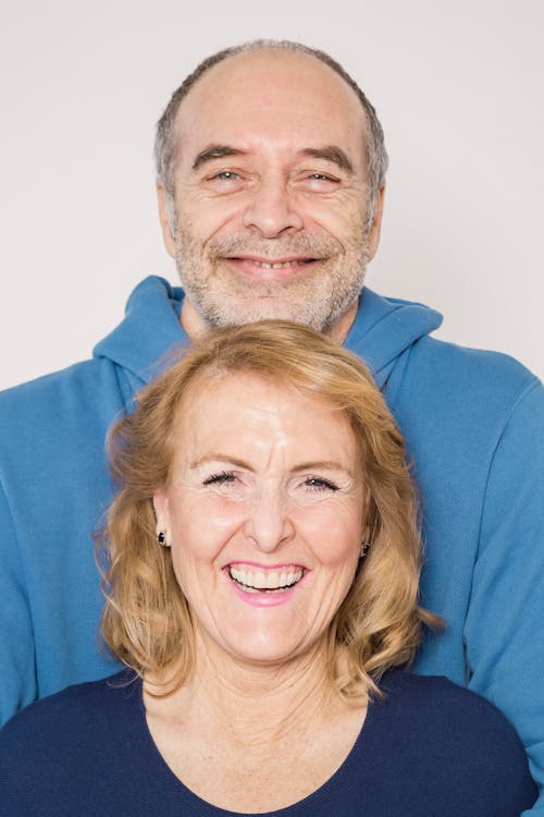 Man in Blue Jacket Beside Woman in Blue Shirt