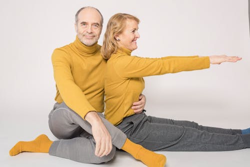 Man in Yellow Sweater Sitting Beside Woman in Yellow Sweater