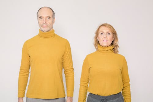 Man in Yellow Turtleneck Long Sleeve Shirt Beside Woman in Yellow Turtleneck Sweater
