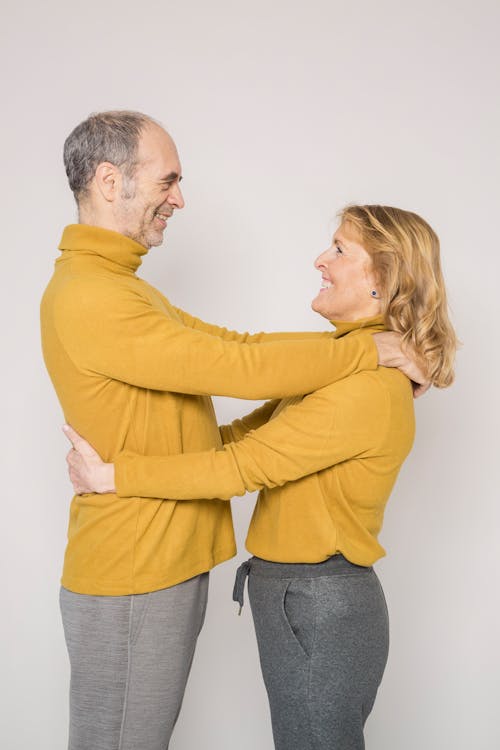 Man in Yellow Sweater Embracing Woman in Yellow Sweater