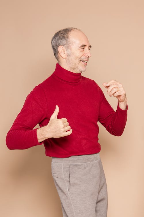 Happy mature man dancing in studio