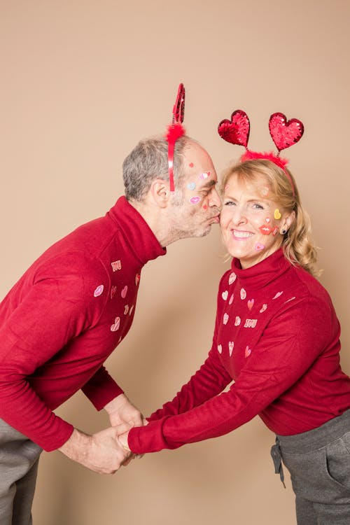 Man in Red Sweater Kissing Woman in Red Sweater