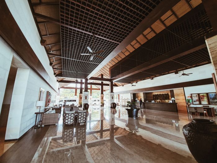 Resort lobby opening onto a tropical pool terrace