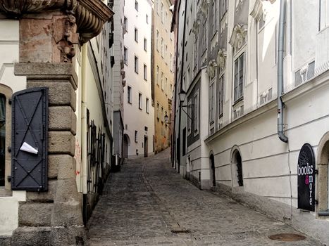 Explore the picturesque narrow alley in Linz with historic architecture and cobblestone path.