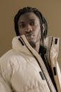 Man with Afro Braids in White Winter Coat