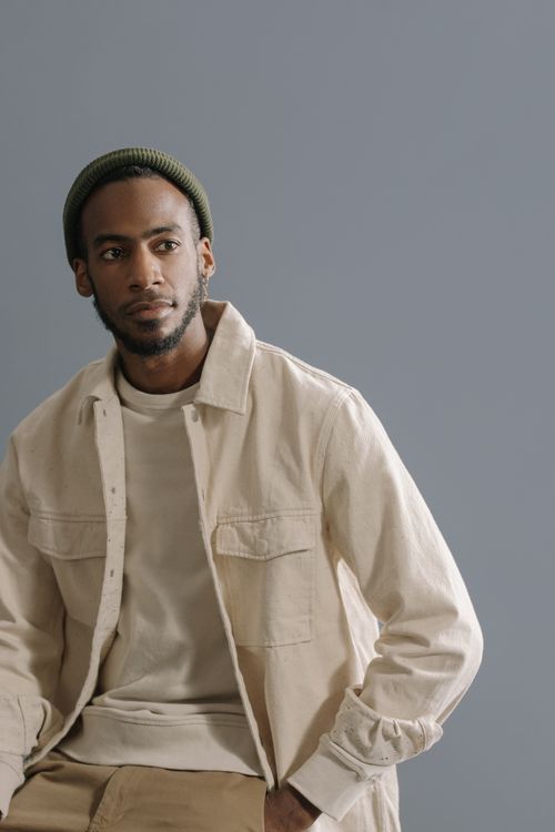 Free Elegant portrait of an African American man in a beige outfit, exuding style and confidence. Stock Photo