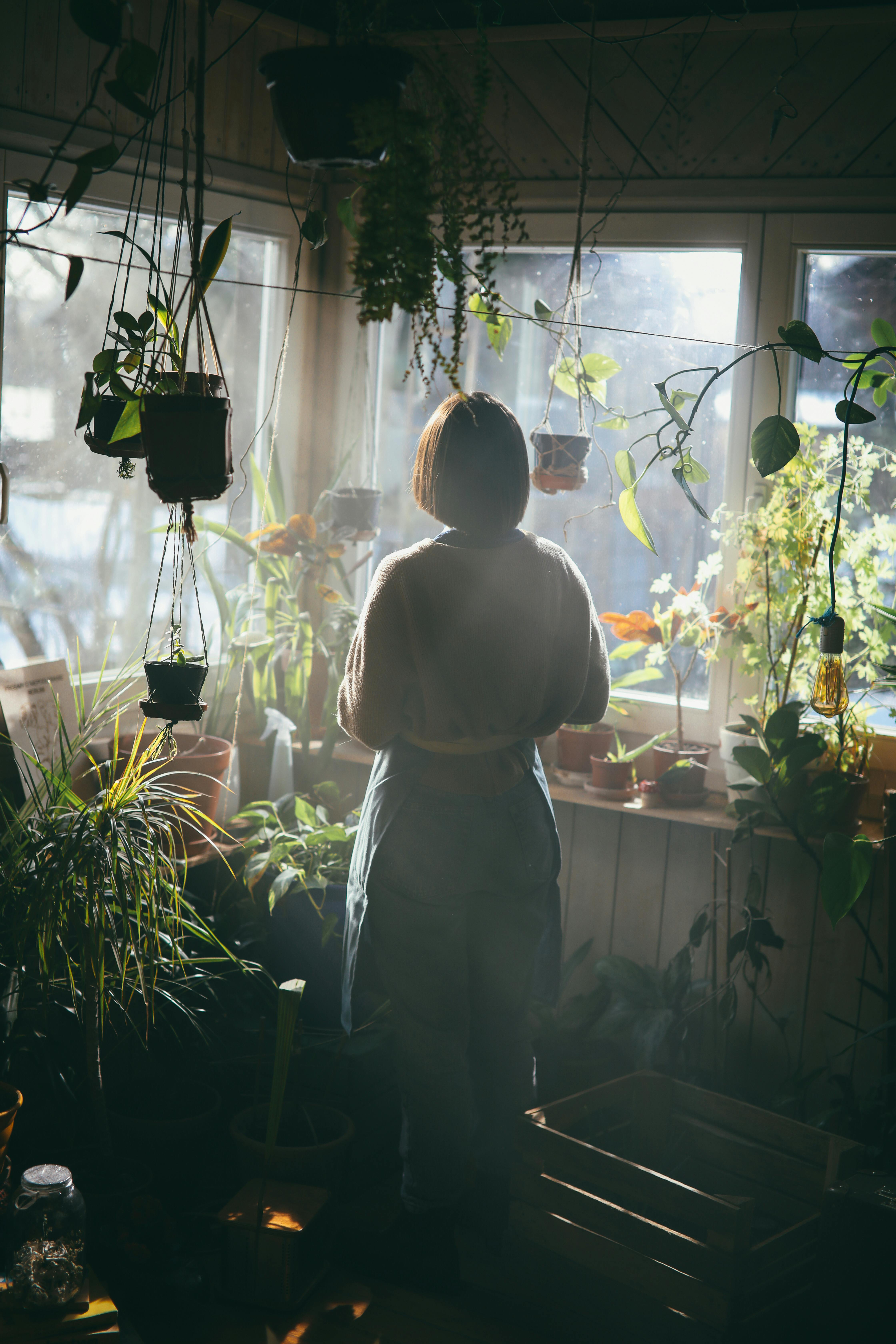 Woman in durable gardening trousers planting vegetables