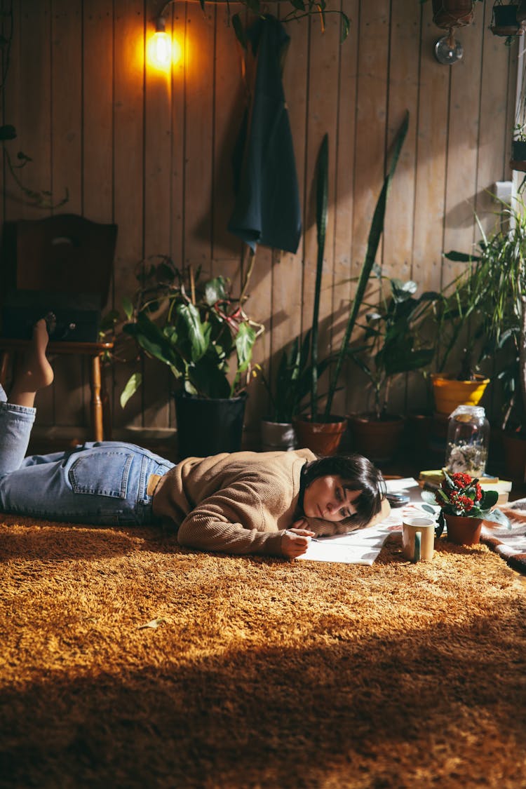 A Woman In Brown Sweater Lying On A Rug Drawing