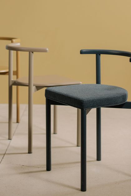 Earth-toned tubular chairs in a bare room — photo by cottonbro studio on Pexels