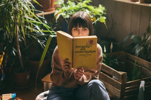 A Woman with Bangs Reading a Book
