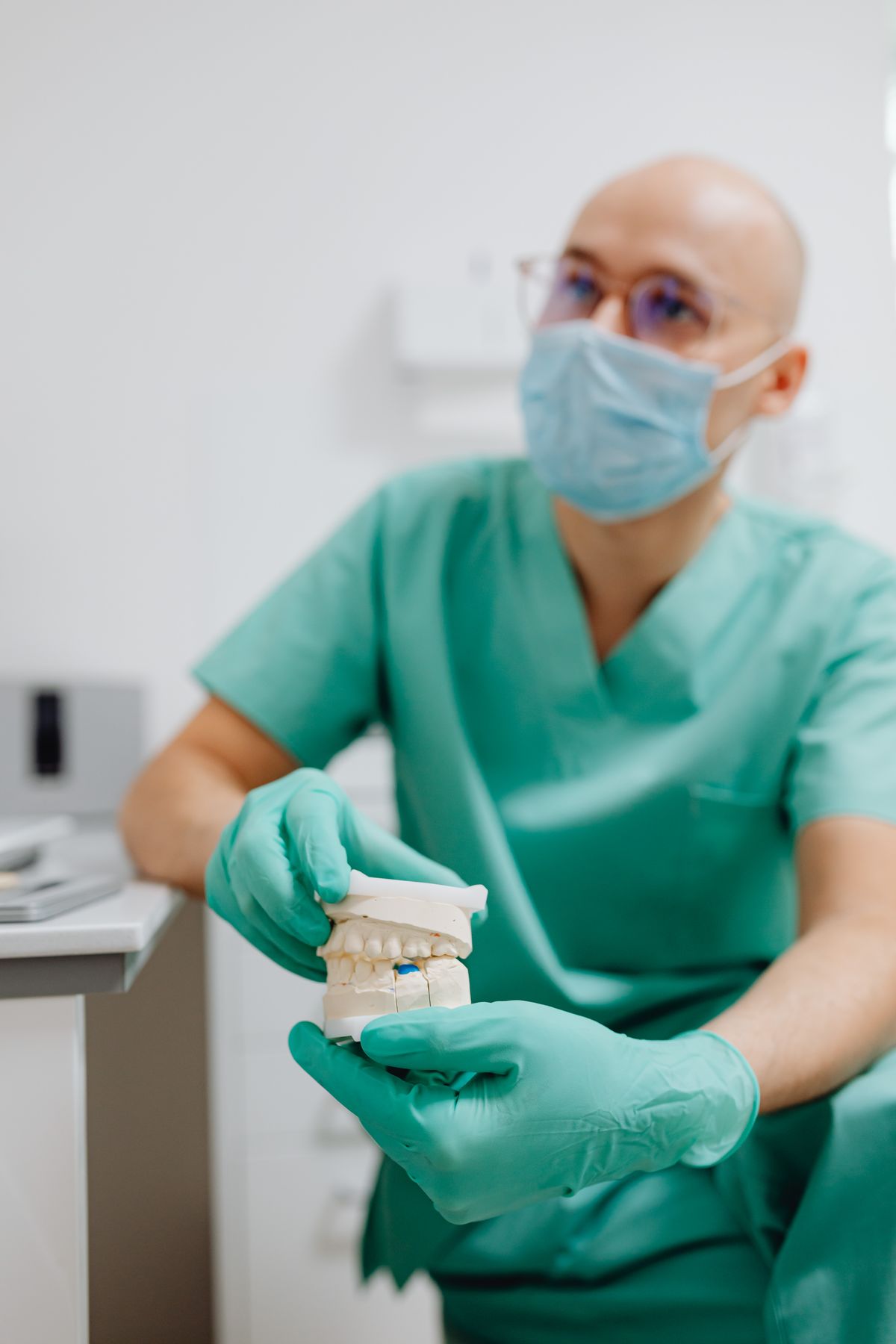 Dentist pointing to an area on an X-ray during a consultation