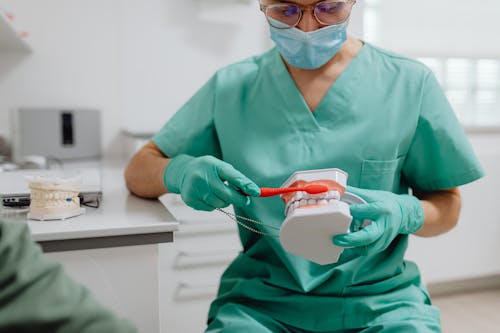 
A Dentist Demonstrating How to Brush Teeth