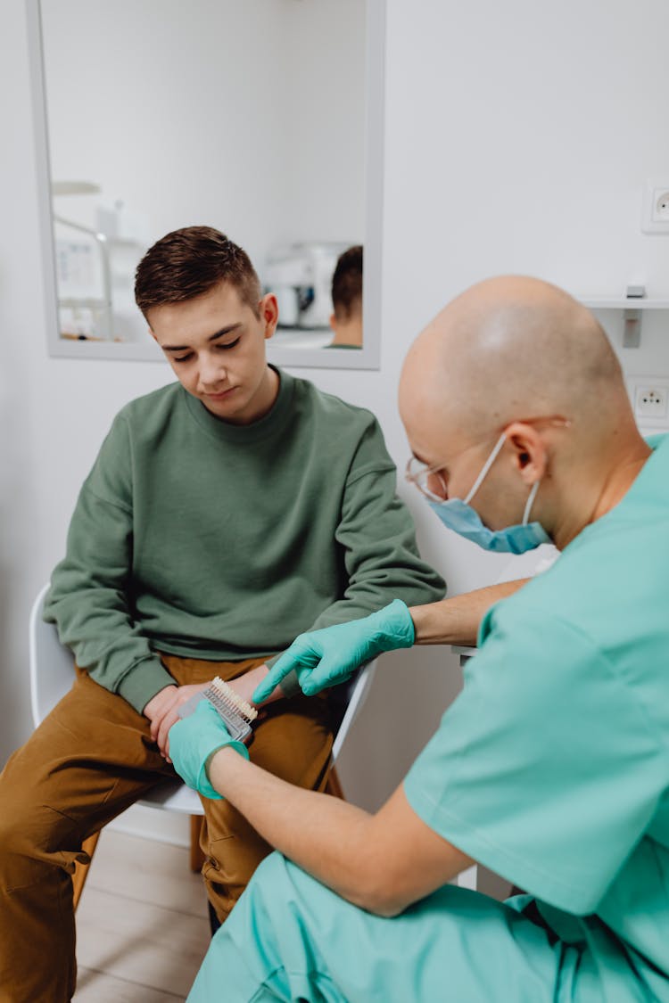 Dentist Having A Discussion With A Patient 