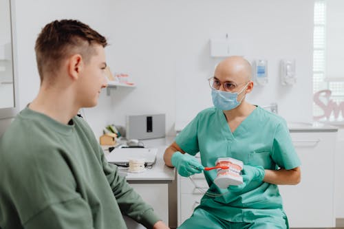 
A Dentist Demonstrating How to Brush Teeth