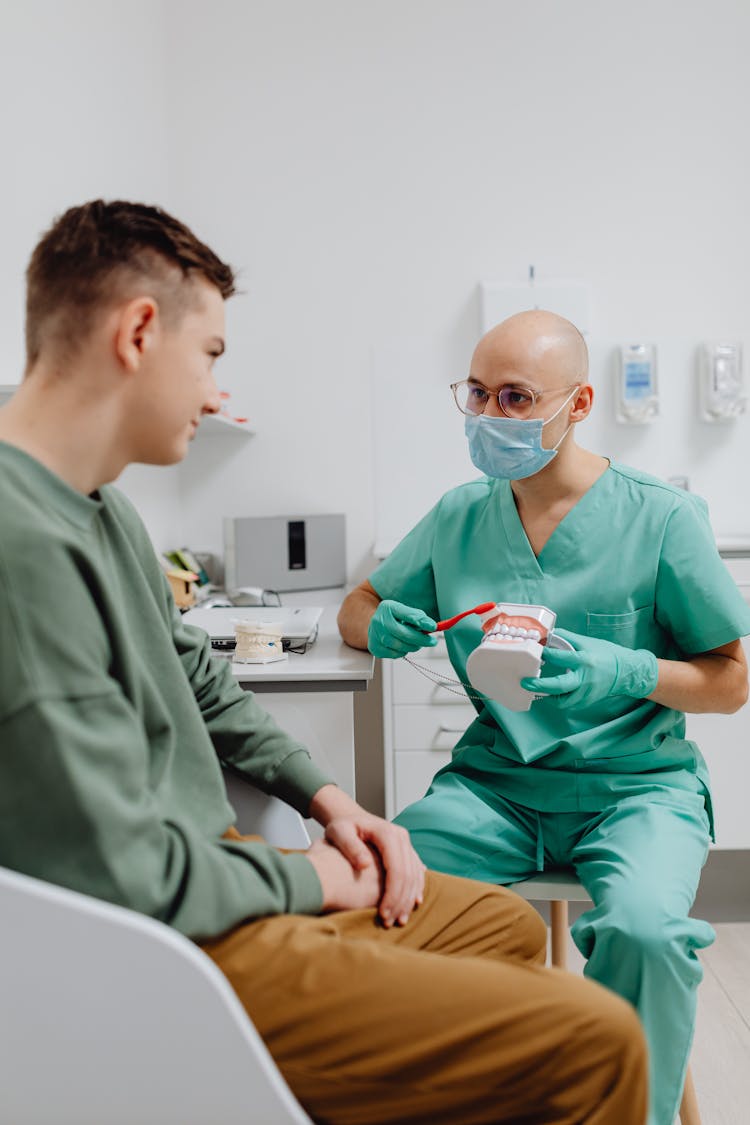 Dentist Having A Discussion With A Patient