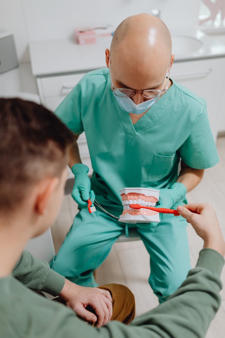 Dentist Having A Discussion With A Patient