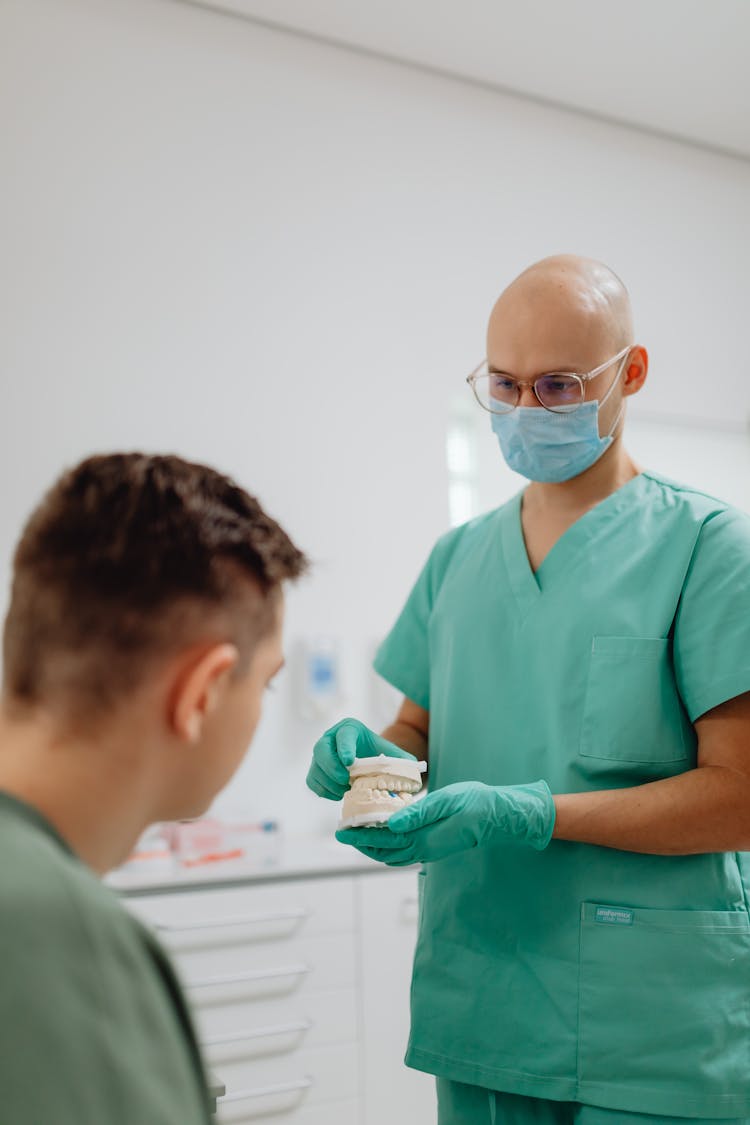 Dentist Having A Discussion With A Patient