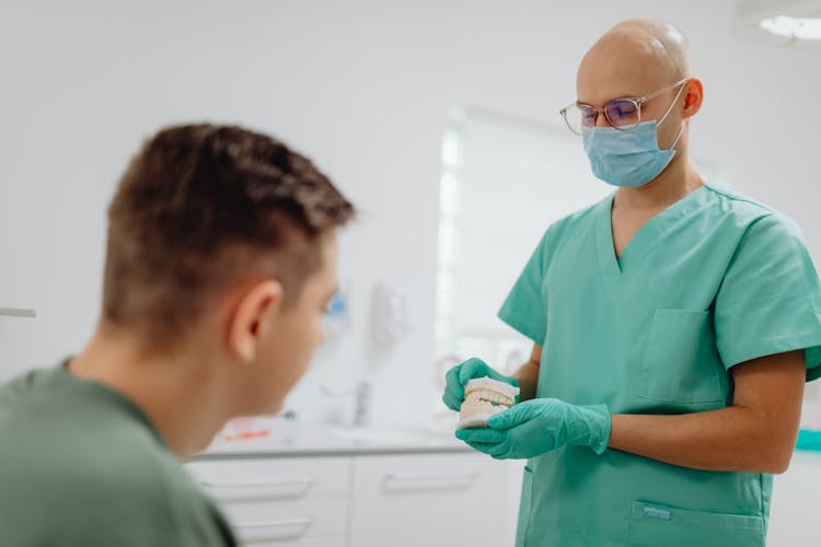 Dentist Having A Discussion With A Patient