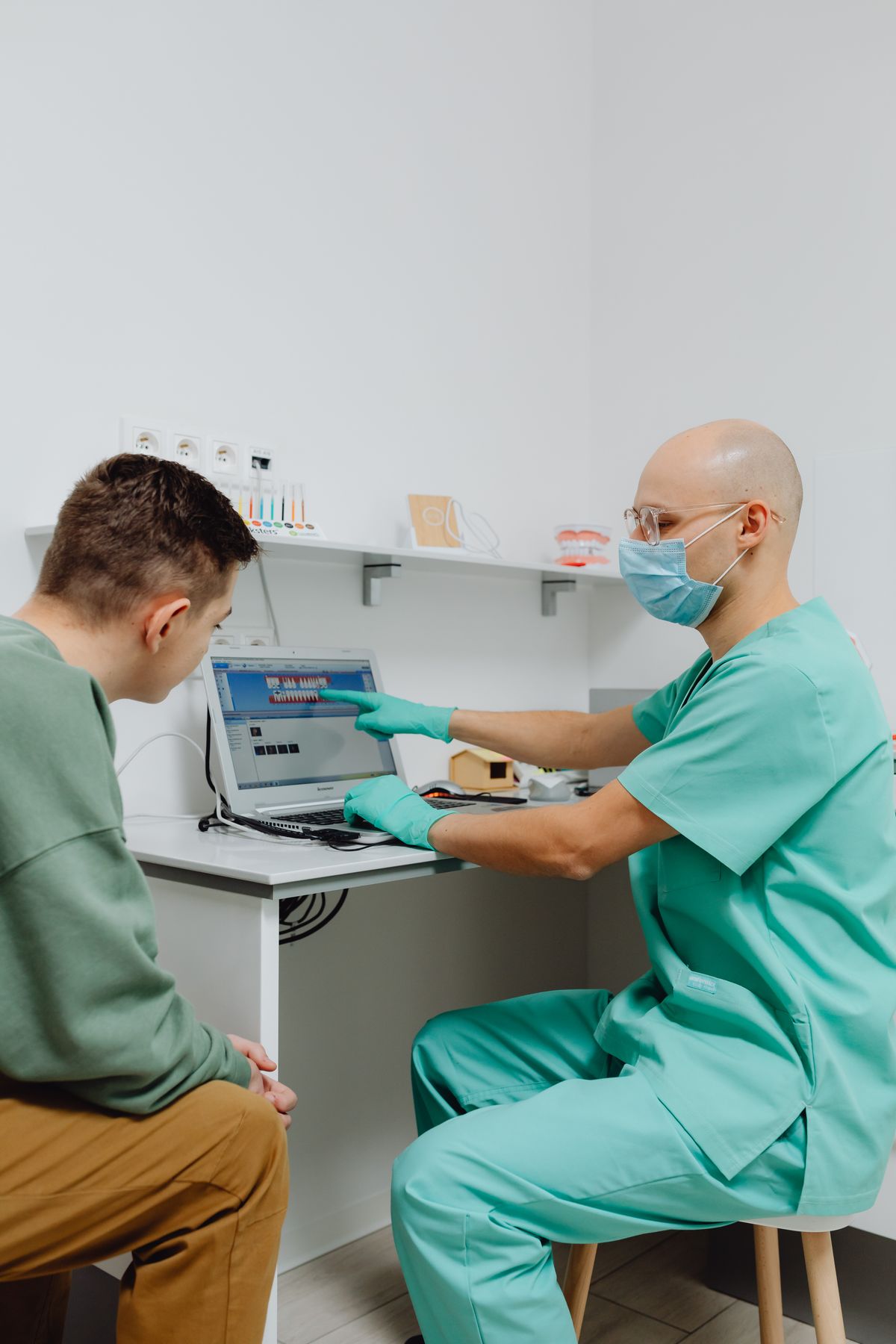 Provider consulting with customer over laptop