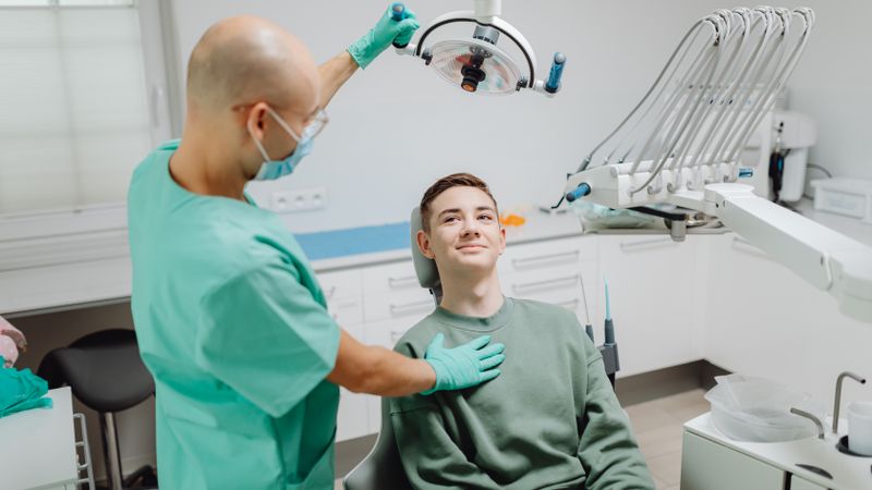 Dentist talking with a patient in a modern dental clinic