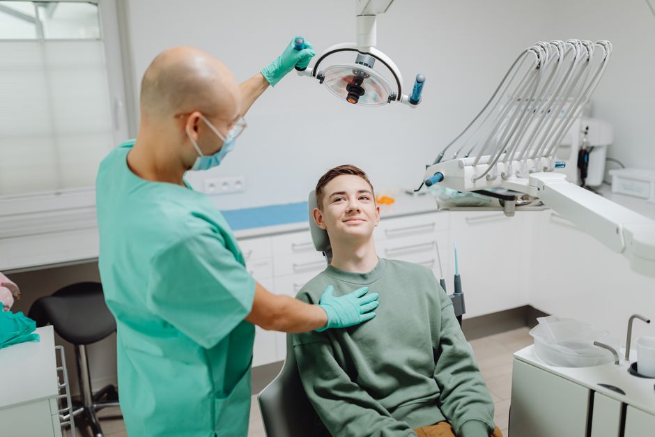 Dentist examining a patient using modern dental equipment in a bright clinic
