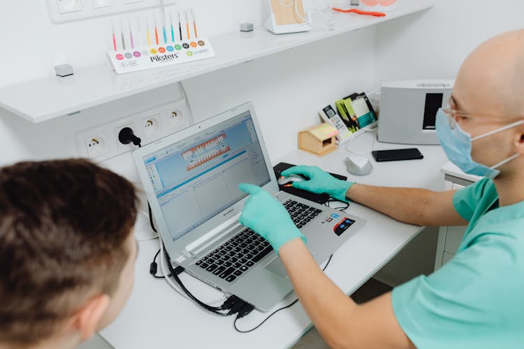 Dentist Having A Discussion With A Patient