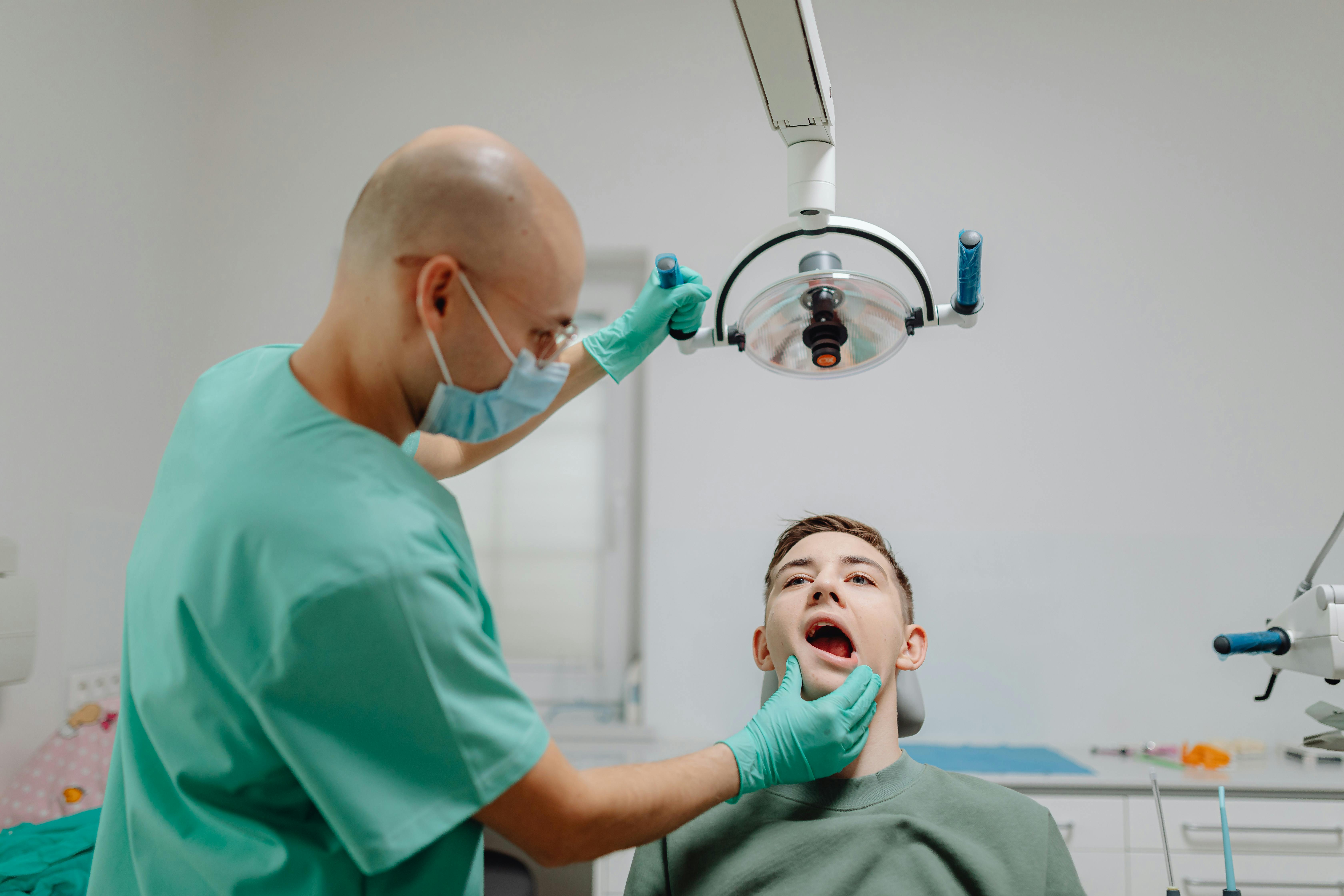 best eye drops for dry eyes Canada - A dentist performs a routine checkup on a patient in a modern dental clinic setting.