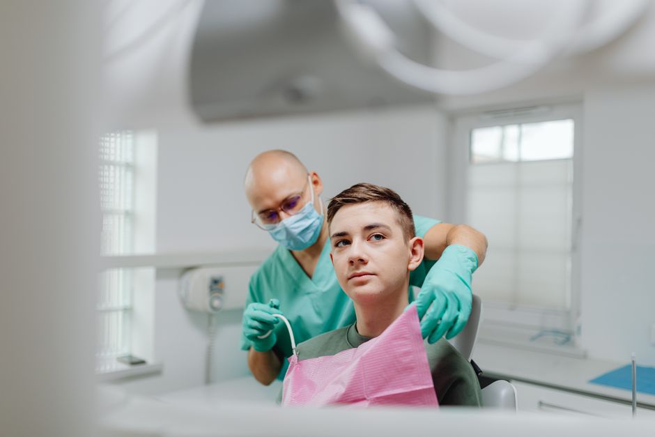 Teenager smiling confidently at a dental checkup