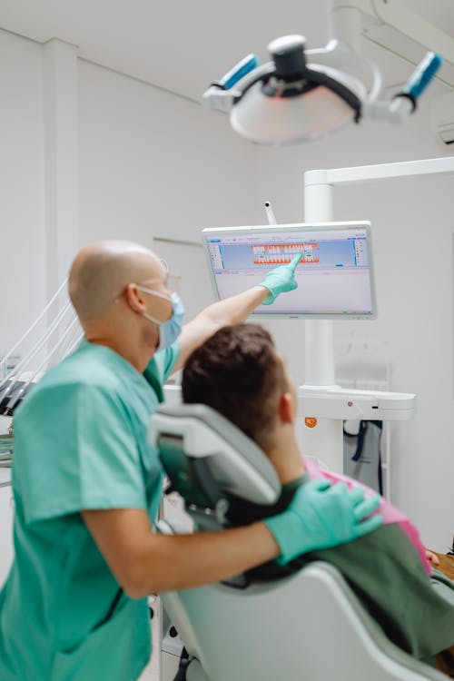 Dentist having a Discussion with a Patient 