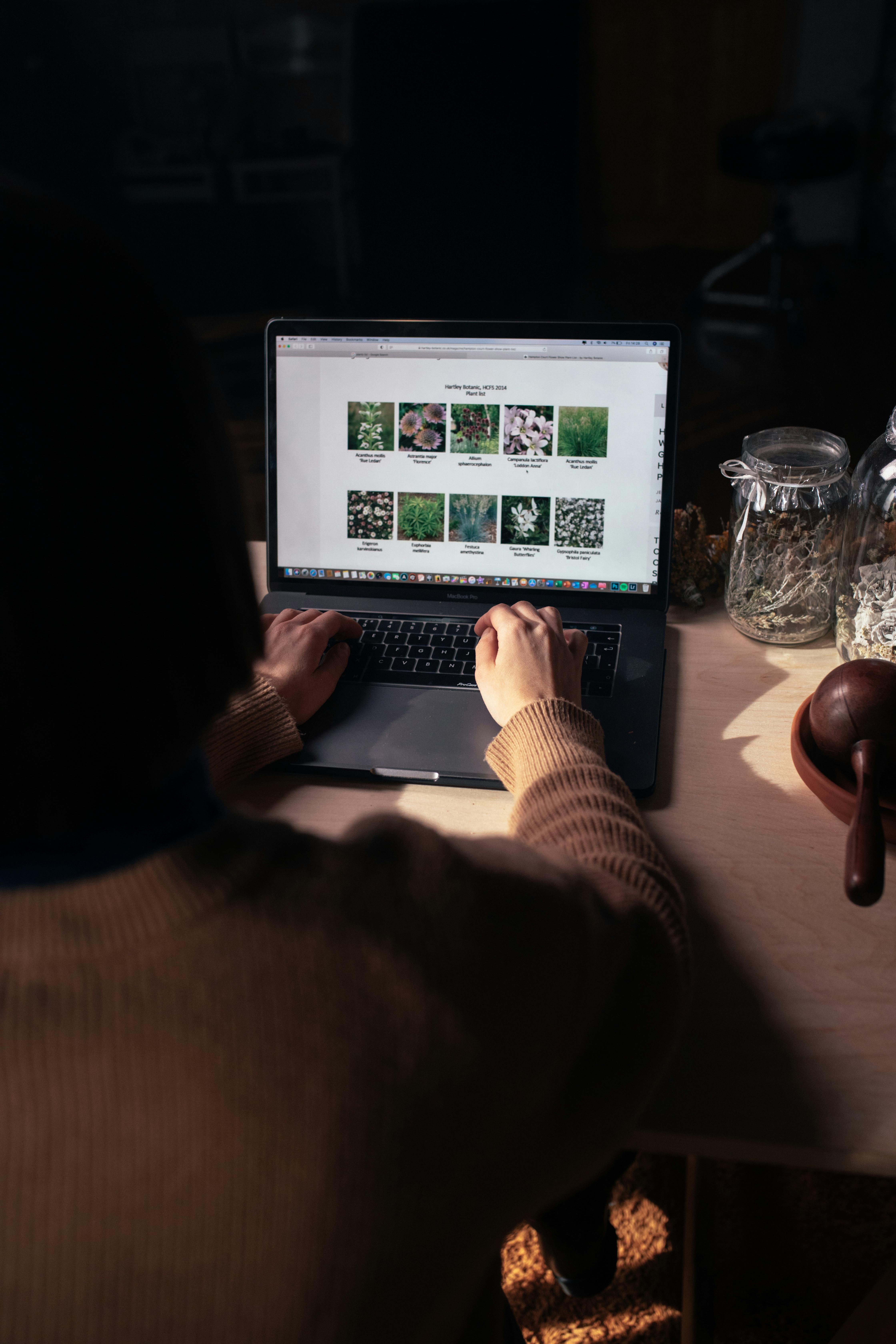 person using macbook pro on table