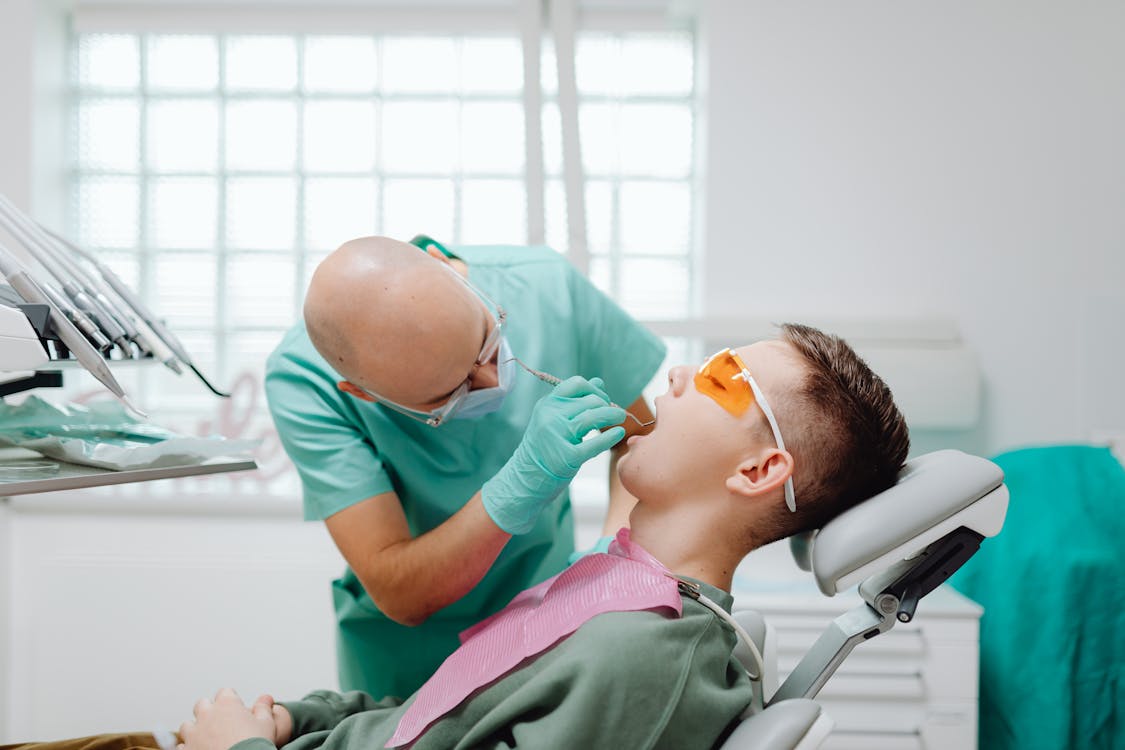 Free A Dentist Checking a Patient's Teeth Stock Photo