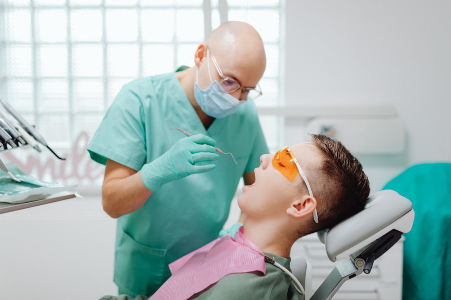 Dentist gently examining a patient