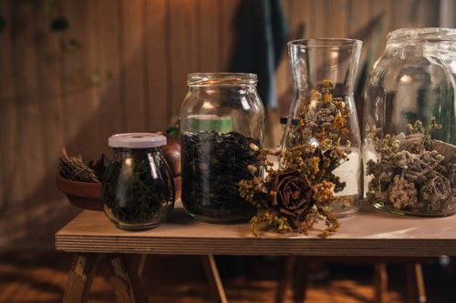 Free A warm, vintage still life of dried botanicals in glass jars indoors. Stock Photo