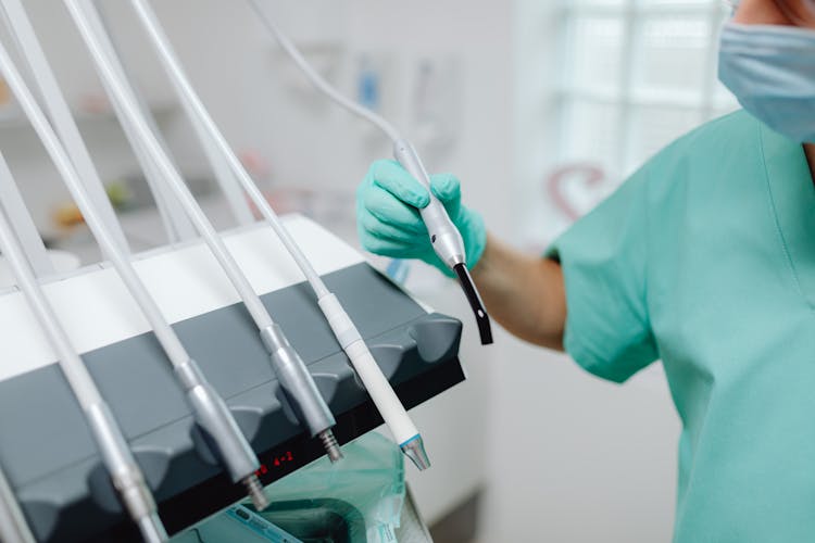 Dentist Using Medical Instruments