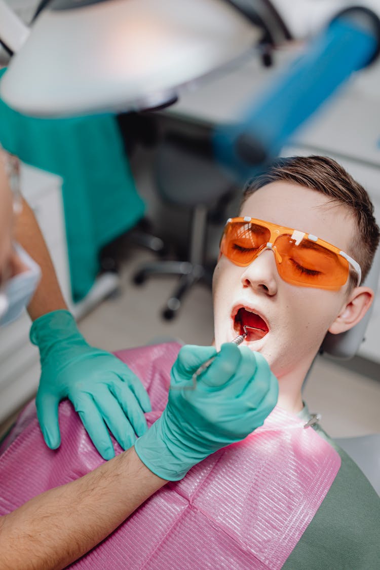 Patient In Glasses In Dentist Chair